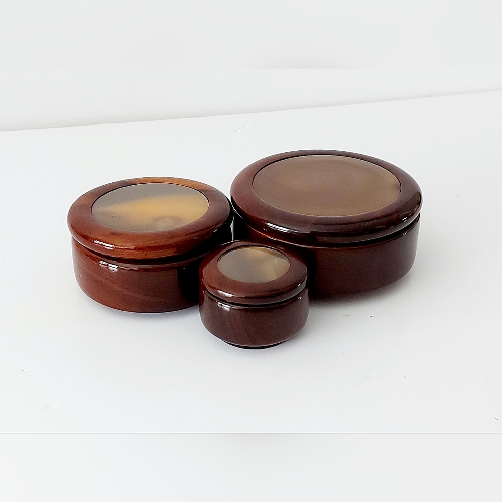 Set of three high quality lacquered wooden containers.